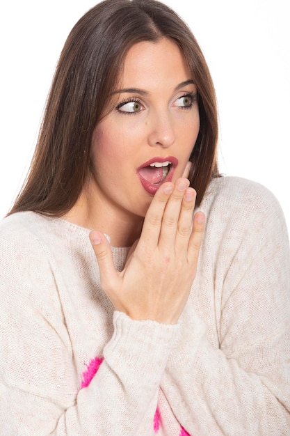 Portrait Of Surprised Young Woman Against white Background