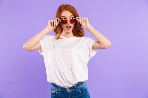 Portrait of a surprised young woman in sunglasses