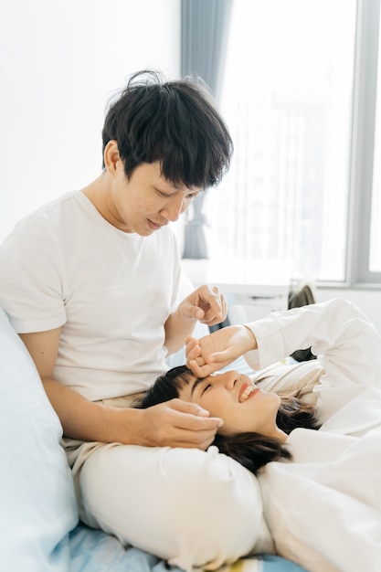 Portrait of sweet young couple on bed