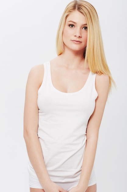 Portrait tank top or woman with beauty underwear or confidence and healthy body on white background Face female person or model with wellness and natural glow with skincare or aesthetic in studio
