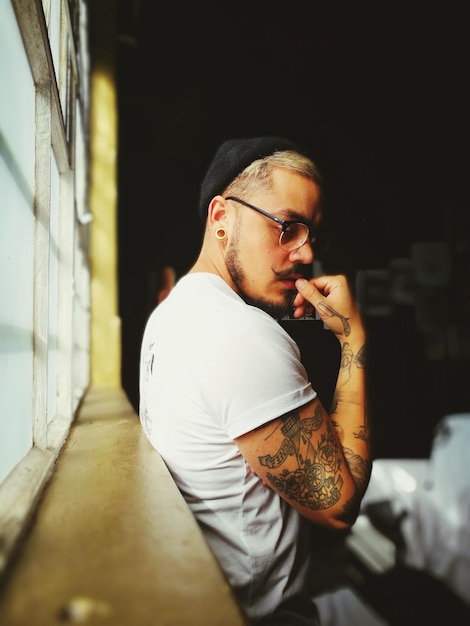 portrait of tattooed man indoors