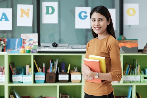 portrait of teacher standing in library