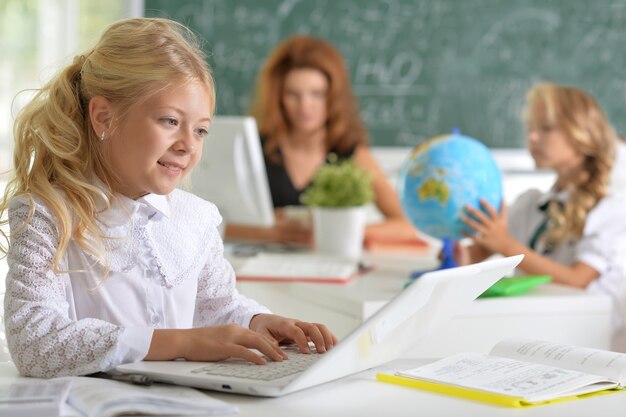 Portrait of teacher with two girls at lesson