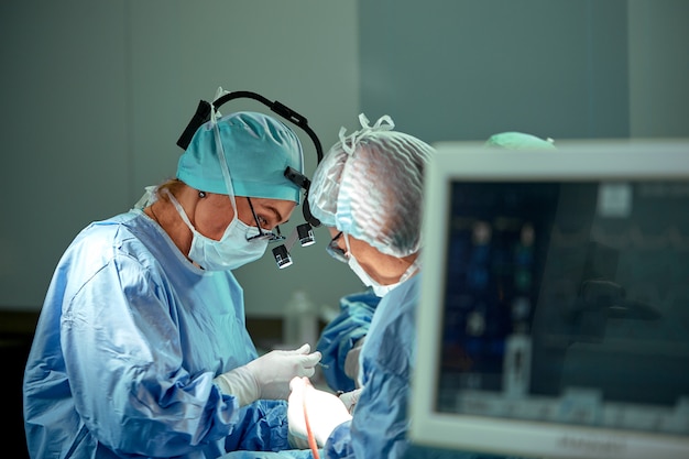 Portrait of a team of surgeons at work. During surgery. Concept medicine, saving lives.