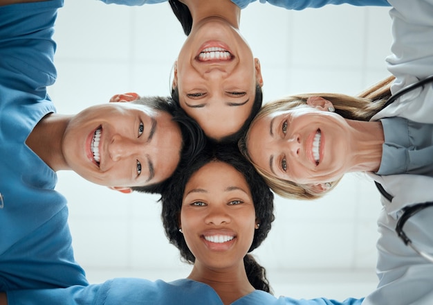 Photo portrait teamwork or faces of doctors in huddle with a happy collaboration for healthcare diversity smiling team building or low angle of medical nurses with group support motivation or mission