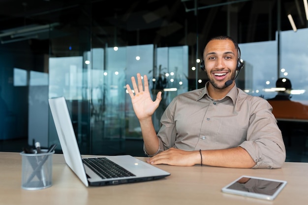 Portrait of tech support and online customer service worker man with video call headset smiling and