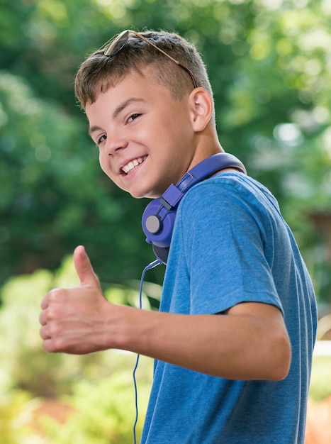 Portrait of a teen boy 1214 year old showing thumb up gesture