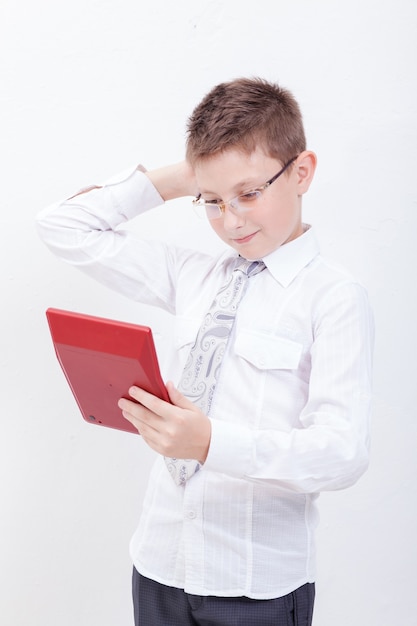 Portrait of teen boy with calculator on white