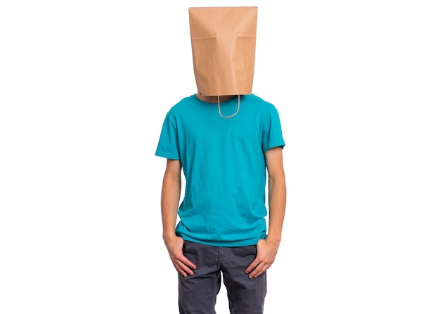 Portrait of teen boy with paper bag over head isolated on white background Child posing in studio