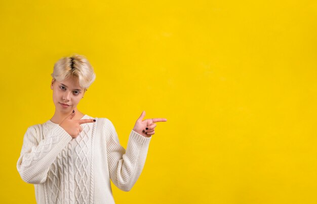 Portrait of teen girl pointing aside