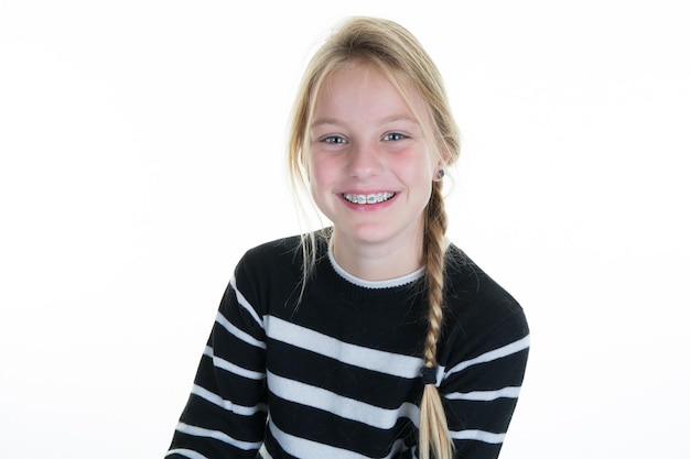 Portrait of teen girl showing dental braces isolated