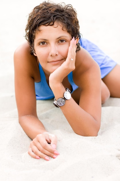 Portrait of teenage boy sitting on sand