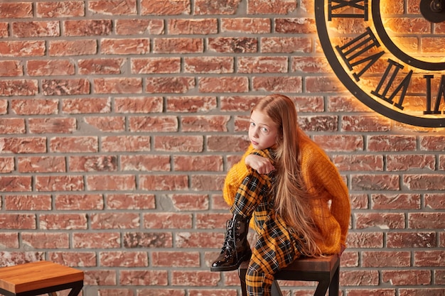Portrait of a teenage girl on the background of a decorated wall
