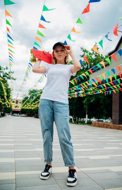 Portrait of a teenage girl in casual clothes Summer skateboarding active lifestyle A student or a student on summer vacation Sports activities