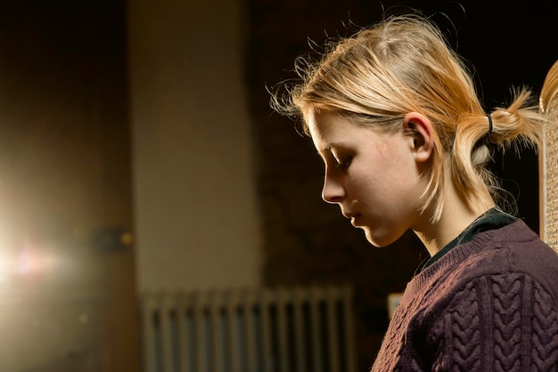 Portrait of a teenage girl in profile in warm light