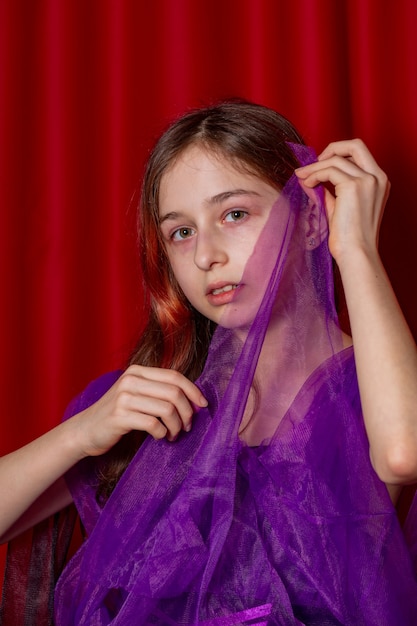 Portrait of a teenage girl in purple with a black dress. Art, model posing.