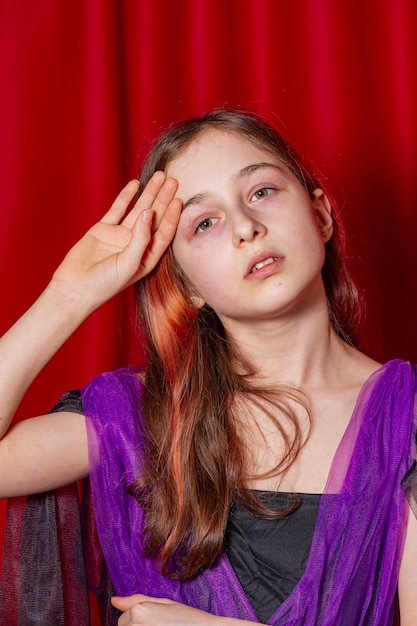 Portrait of a teenage girl in purple with a black dress. Art, model posing.