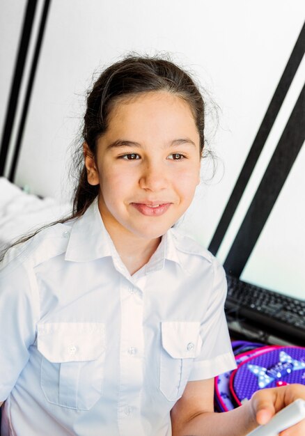 Photo portrait of a teenage girl in a school uniform