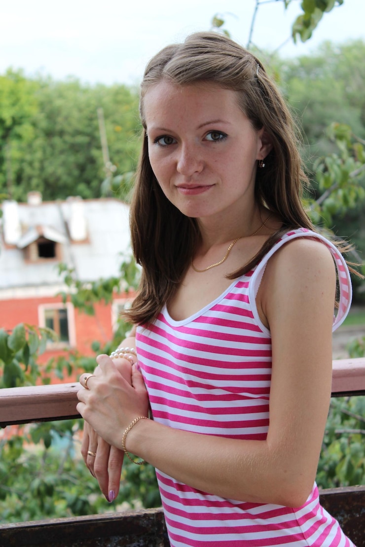 Portrait of teenage girl standing against plants