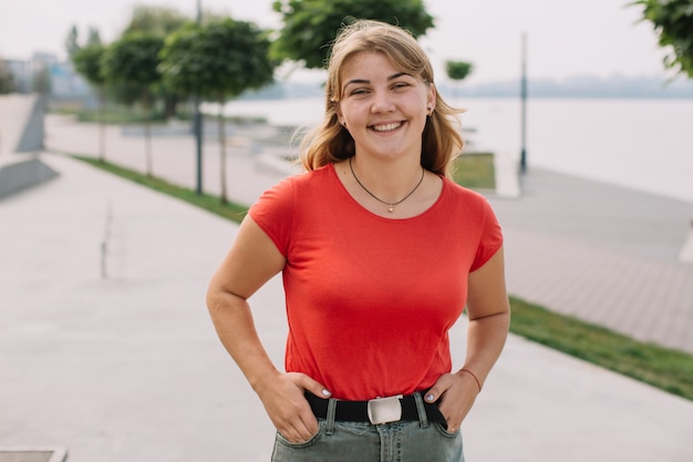 Portrait of a teenage girl who smiles on the street.