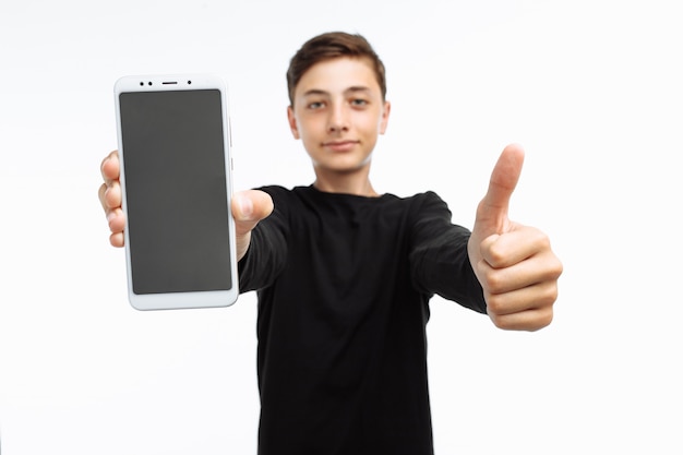 Portrait of a teenager holding a phone with a white screen