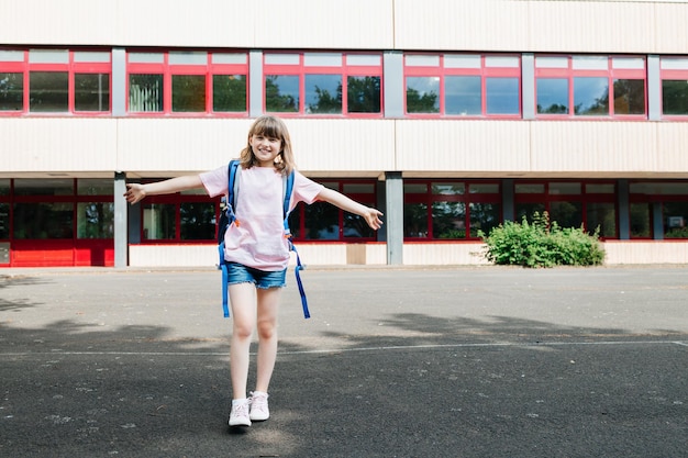 Photo portrait of a teenager schoolgirl in front of the school building children begin the school year