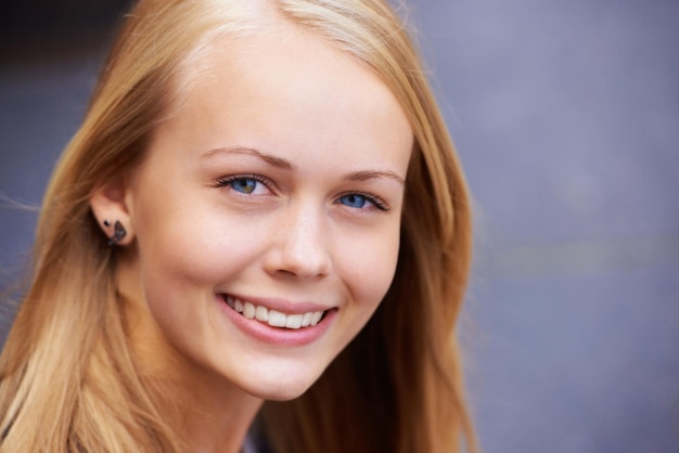 Portrait teenager and smile for youth happiness or positive student mindset or education motivation Young woman happy face and studying confidence smiling headshot or girl empowerment in Sweden