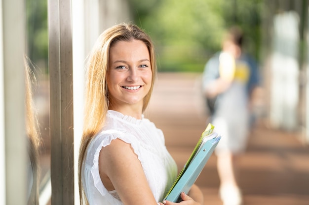 Portrait of teenager student girl against wall