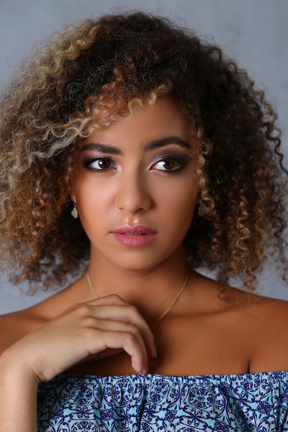 Portrait of tender female with curly brown hair