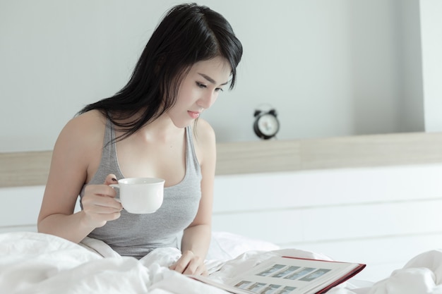 portrait thailand woman drinking relaxation in the bedroom in holliday