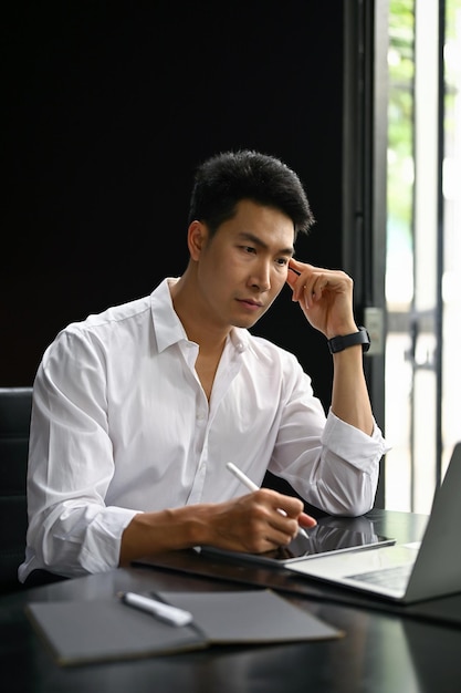 Portrait of a thoughtful businessman planning and working on his business project