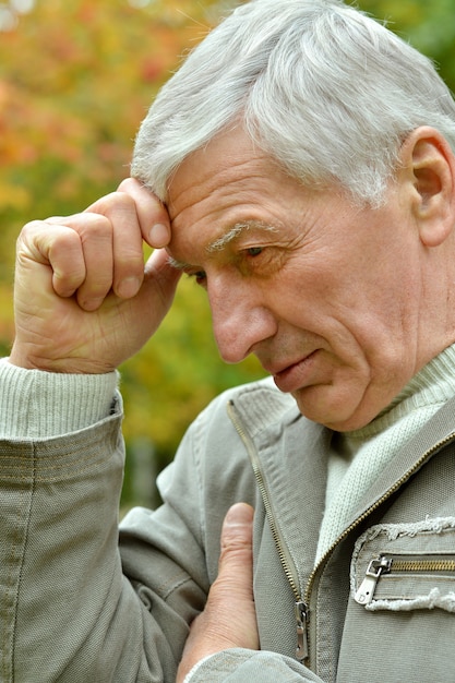 Portrait of thoughtful elderly man in autumn