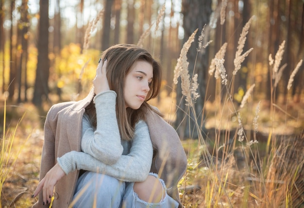 Portrait of a thoughtful and sad girl. Autumn colors . Lifestyle. Autumn mood. Forest