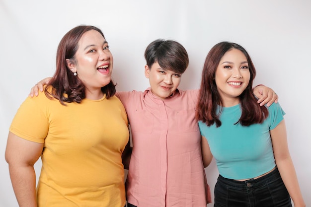 A portrait of three friends are smiling expressing happy feeling isolated by white background