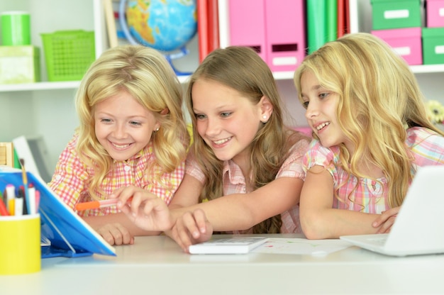 Portrait of a three little girls doing homework