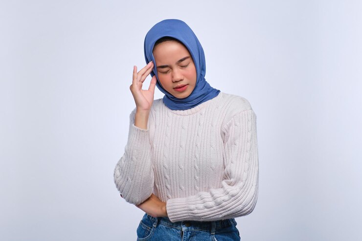 疲れた若いアジア人女性の肖像画 ⁇ 頭痛や片頭痛に苦しみ ⁇ 白い背景に孤立した鬱を感じています ⁇ 