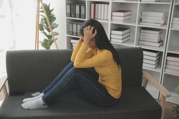 Portrait of tired young business Asian woman work with documents tax laptop computer in office Sad unhappy Worried Depression or employee life stress concept