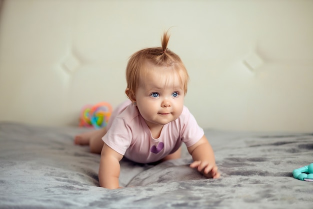 Portrait of a toddler a child playing on the bed