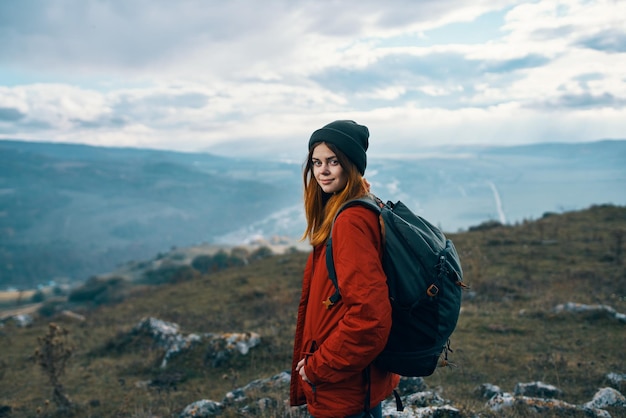 Portrait of a traveler in the mountains in nature rock landscape clouds sky model