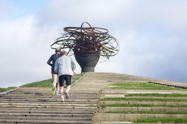 Portrait of two active senior man doing exercise outdoors