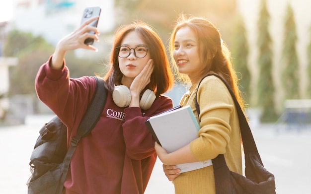 Portrait of two beautiful asian female college students at school