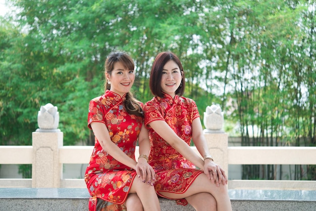 Portrait two beautiful asian women in Cheongsam dressThailand peopleHappy Chinese new year concept