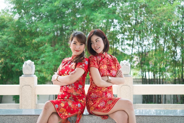 Portrait two beautiful asian women in Cheongsam dressThailand peopleHappy Chinese new year concept