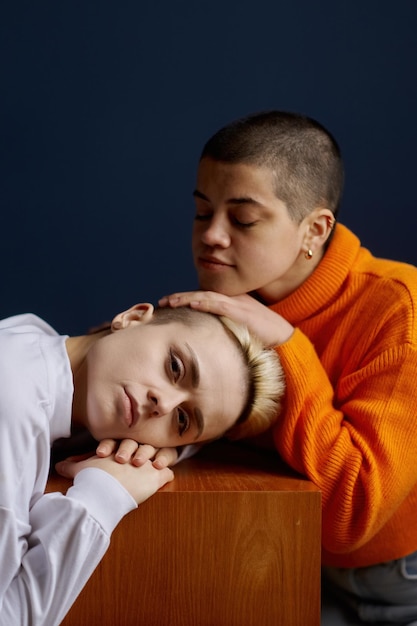 Portrait of two beautiful young lesbian woman couple posing for camera. LGBT, romance, love and same-sex relationships concept