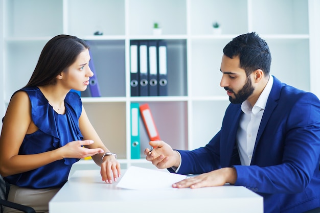 Portrait of two business people at work.