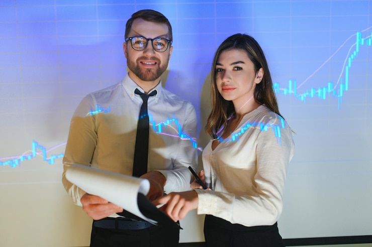 Photo ビジネス グラフの背景にビジネス服を着た 2 人のビジネスマンの男性と女性の肖像画