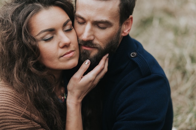 Portrait of two caucasian lovers. Young couple is hugging on autumn day outdoors. Valentine's Day. Concept of love and family.