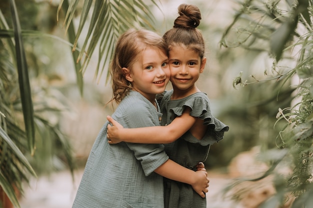 Portrait of two charming smiling girls Friendship linen clothing environmental friendliness