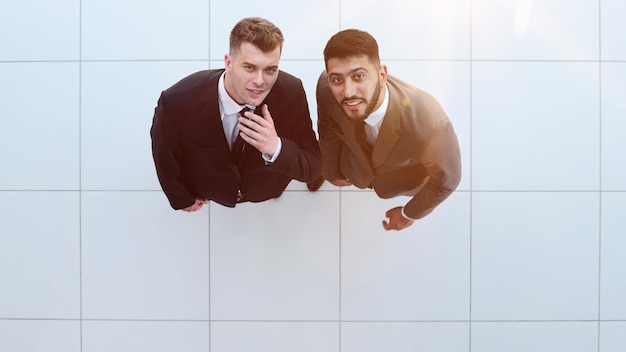 Portrait of two concentrated businessmen partners dressed in formal suit