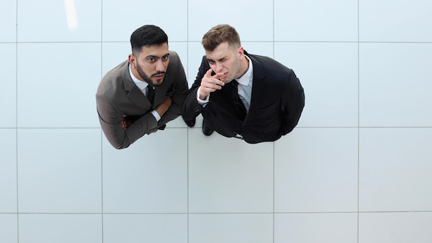 Portrait of two concentrated businessmen partners dressed in formal suit